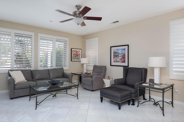 living room with light tile patterned floors and ceiling fan