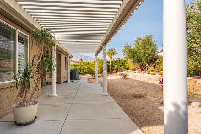 view of patio featuring a mountain view, central air condition unit, and a pergola