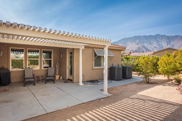 view of patio featuring a mountain view and cooling unit