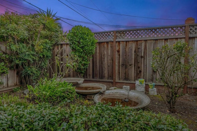 view of yard at dusk