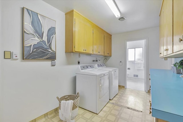 washroom featuring cabinets and washing machine and dryer