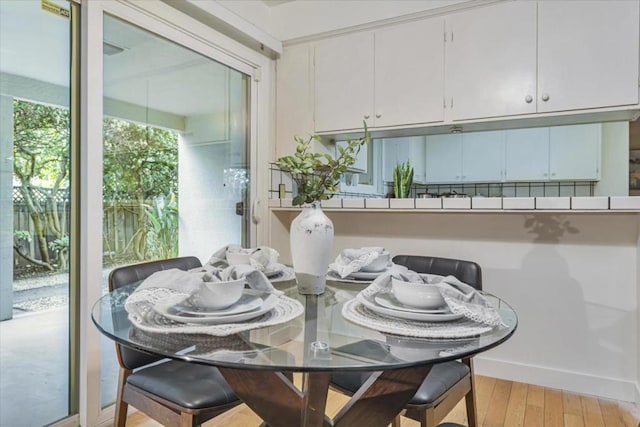 dining space with light hardwood / wood-style floors