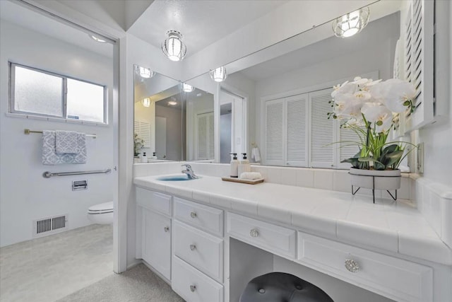 bathroom featuring vanity and toilet