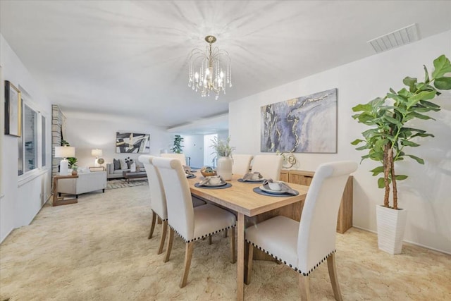 dining space featuring a notable chandelier