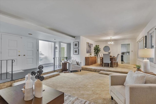 living room with a chandelier and carpet