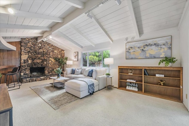 living room featuring lofted ceiling with beams and a fireplace