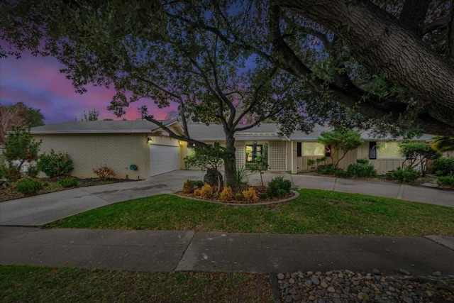 single story home with a yard and a garage