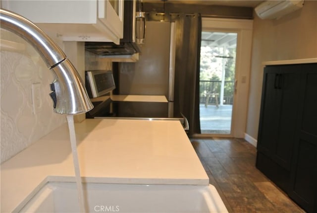 kitchen with dark hardwood / wood-style floors and a wall mounted AC