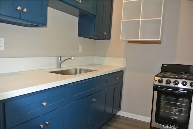 kitchen with dark hardwood / wood-style floors, blue cabinetry, sink, and range with gas cooktop