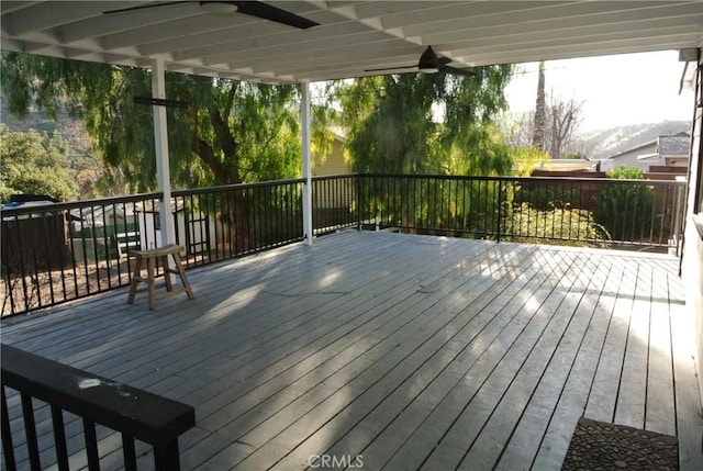 wooden terrace featuring ceiling fan