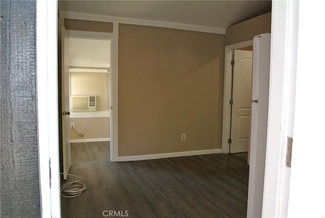 spare room featuring ornamental molding and dark wood-type flooring