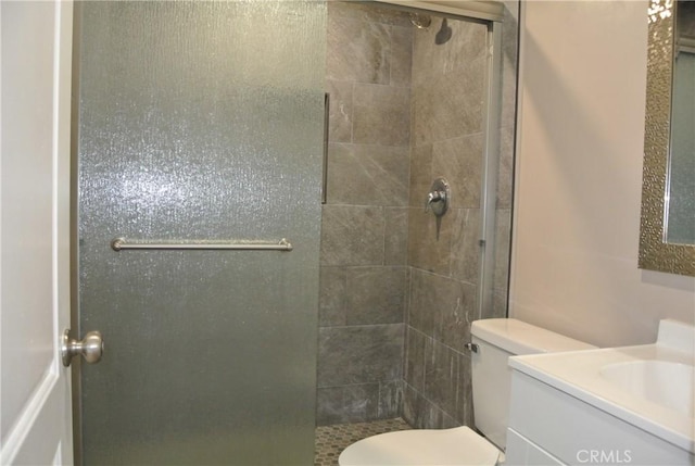 bathroom featuring toilet, vanity, and walk in shower