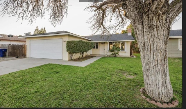 ranch-style home with a garage and a front yard