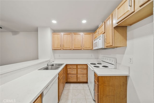 kitchen featuring sink, light tile patterned floors, light brown cabinetry, and white appliances