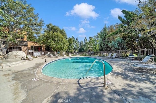 view of swimming pool with a patio