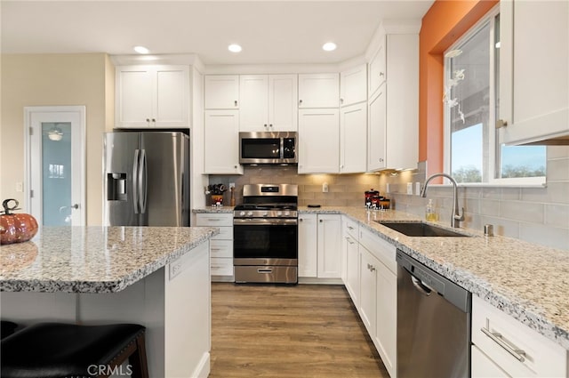 kitchen with white cabinetry, appliances with stainless steel finishes, and sink