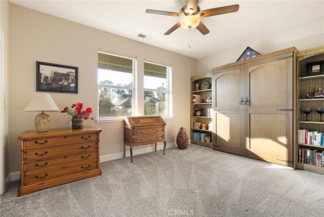 sitting room featuring light colored carpet and ceiling fan