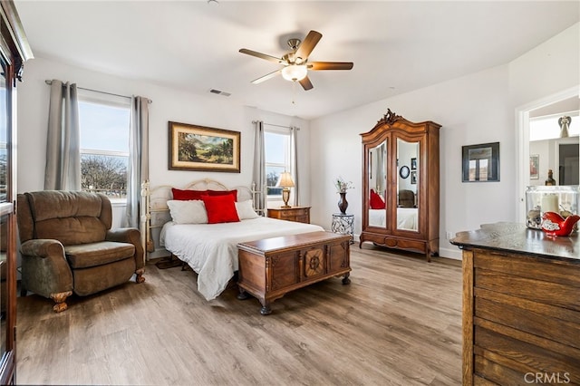 bedroom with hardwood / wood-style floors and ceiling fan