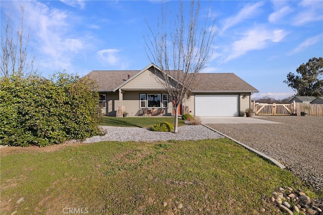 ranch-style house featuring a garage and a front lawn