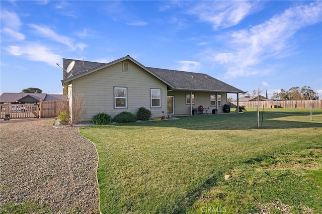 back of house with a lawn