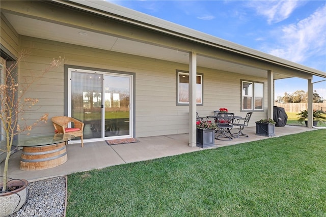 rear view of property with a lawn and a patio area