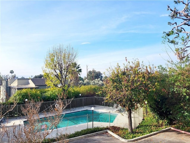 view of swimming pool with a patio area, fence, and a fenced in pool