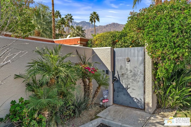 view of gate with a mountain view