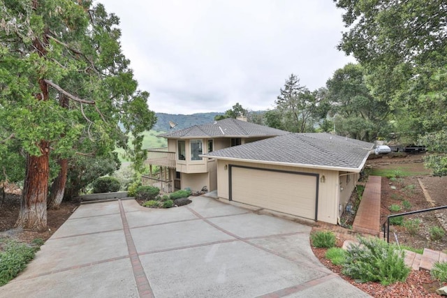 view of front of property featuring a balcony and a garage