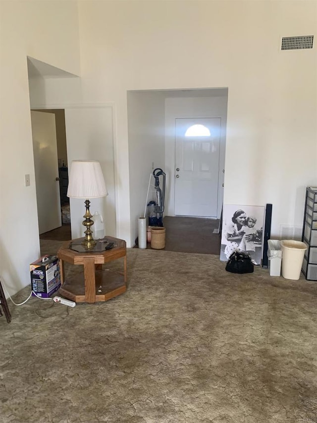 entryway with dark colored carpet