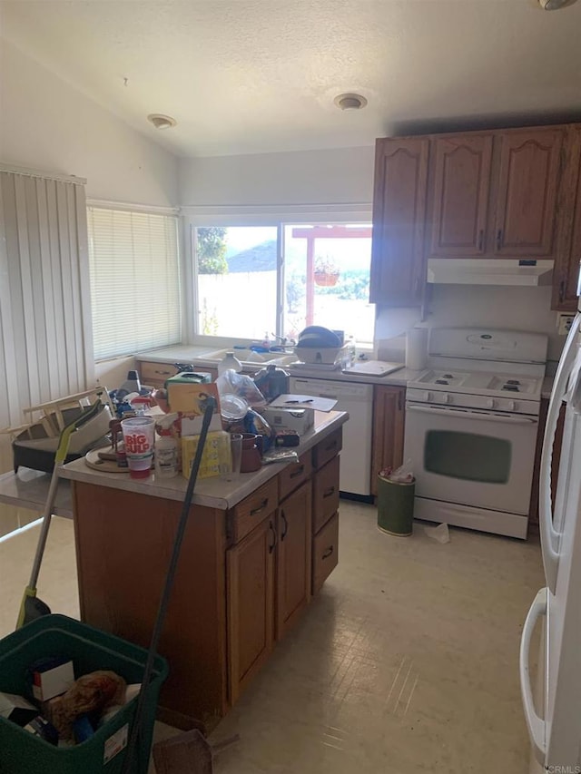 kitchen featuring lofted ceiling and white gas range