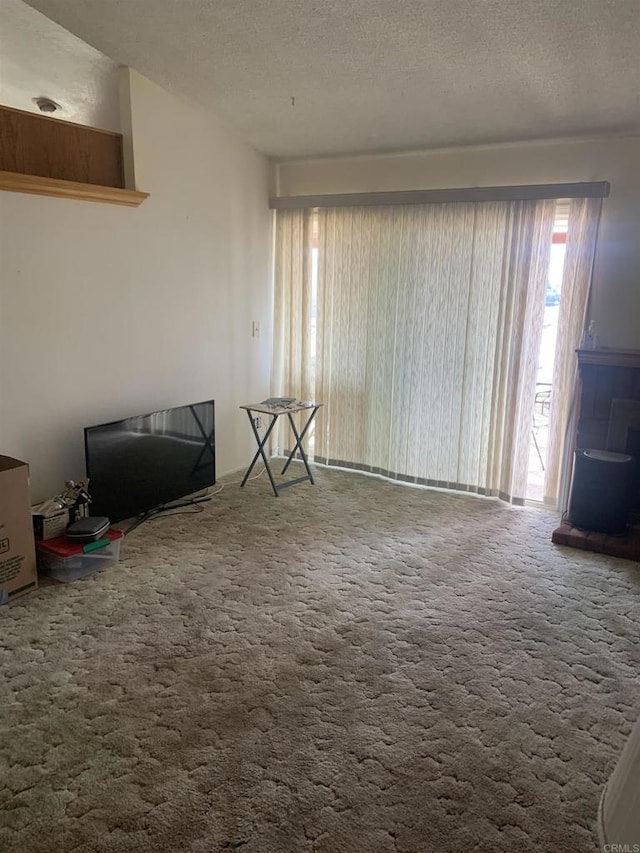 carpeted living room featuring a textured ceiling