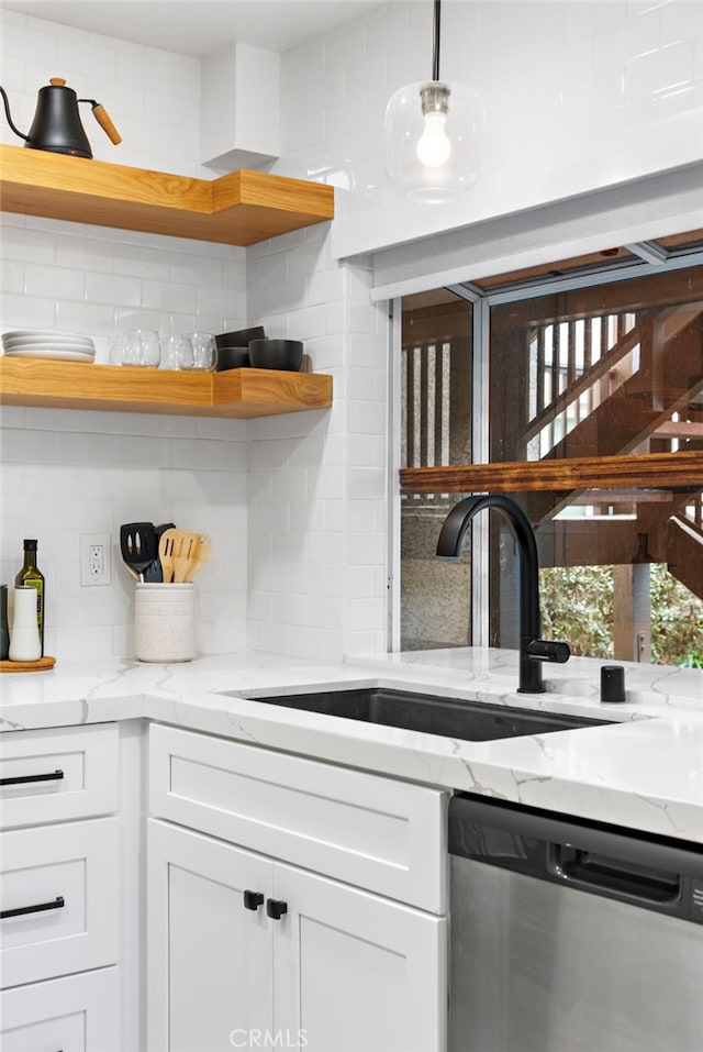 kitchen featuring white cabinets, dishwasher, backsplash, open shelves, and a sink