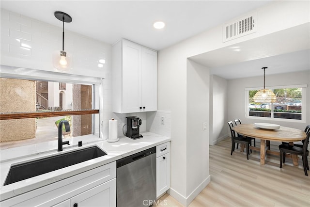 kitchen featuring sink, hanging light fixtures, dishwasher, decorative backsplash, and white cabinets