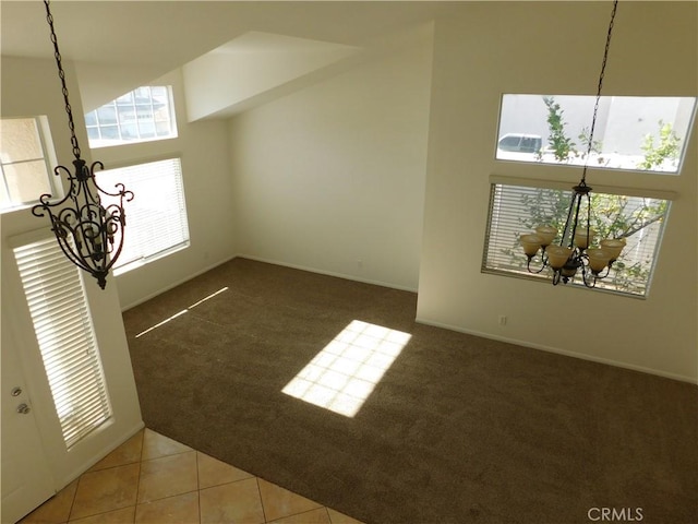 interior space with carpet floors and an inviting chandelier