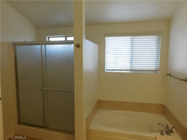 bathroom with plenty of natural light and separate shower and tub