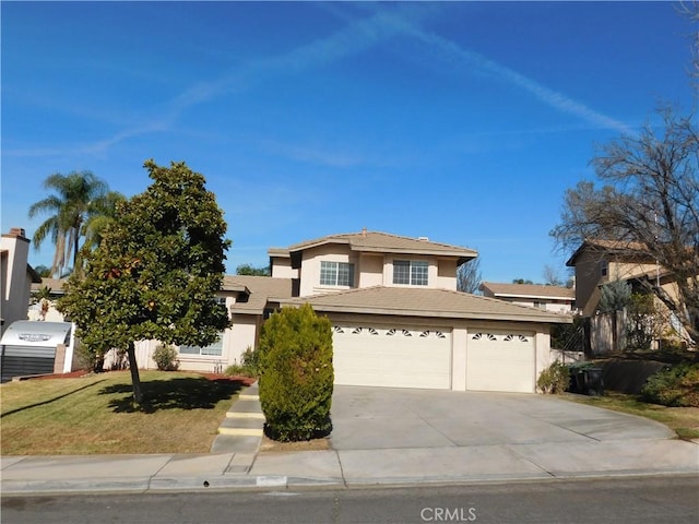 view of property featuring a garage and a front yard