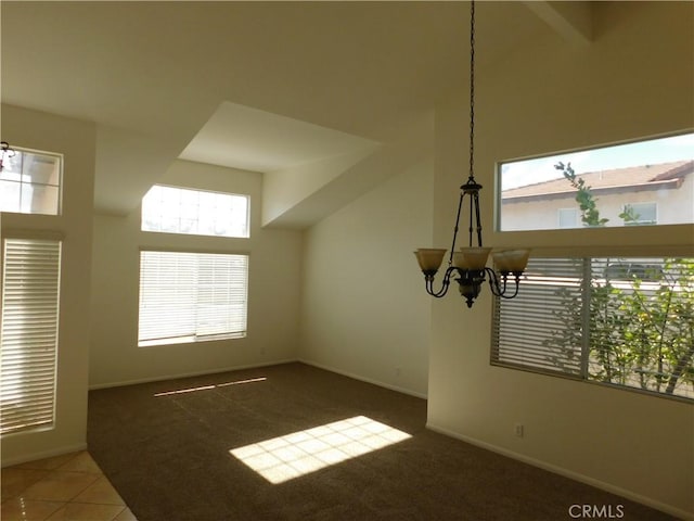 interior space with a notable chandelier and dark colored carpet