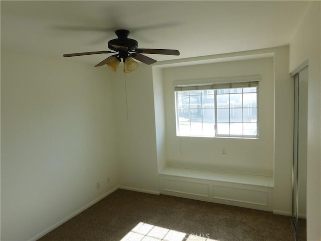 unfurnished room featuring dark colored carpet