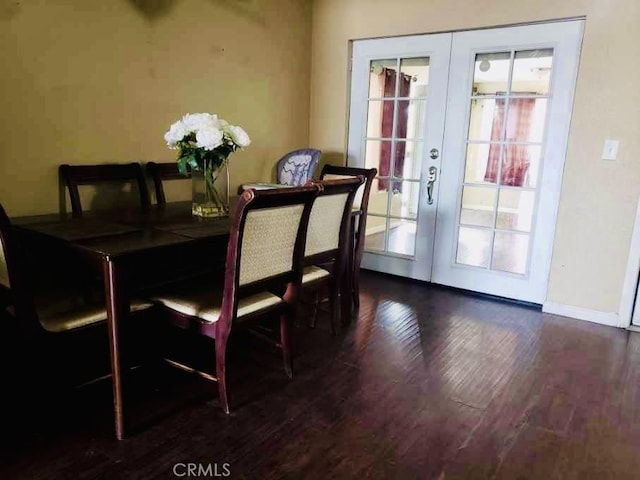 dining space featuring dark wood-type flooring and french doors