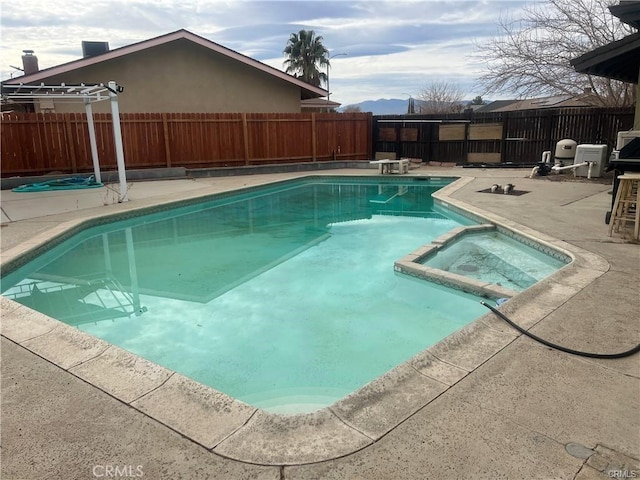 view of swimming pool with an in ground hot tub, a diving board, and a patio