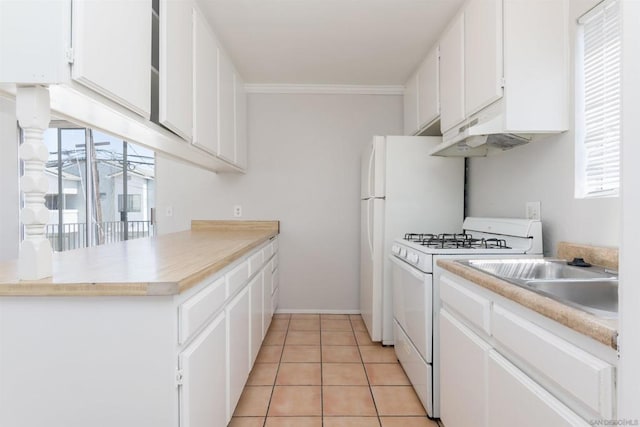 kitchen with crown molding, light tile patterned floors, white cabinets, and white gas range oven