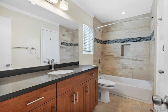 full bathroom featuring tiled shower / bath, vanity, ornamental molding, toilet, and tile patterned floors