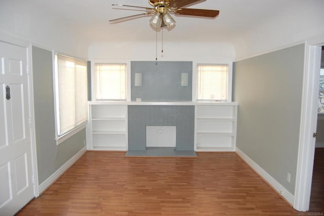 unfurnished living room with plenty of natural light, hardwood / wood-style floors, and ceiling fan