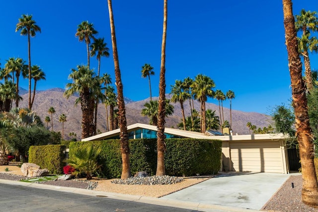 view of front of property featuring a mountain view and a garage