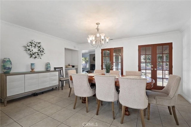 dining area featuring ornamental molding, light tile patterned flooring, an inviting chandelier, and french doors