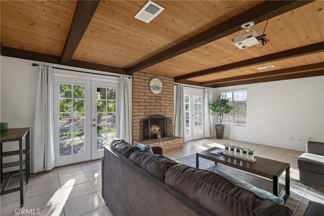 living room featuring light tile patterned flooring, a wealth of natural light, and french doors