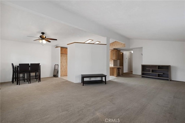 carpeted living room with vaulted ceiling and ceiling fan