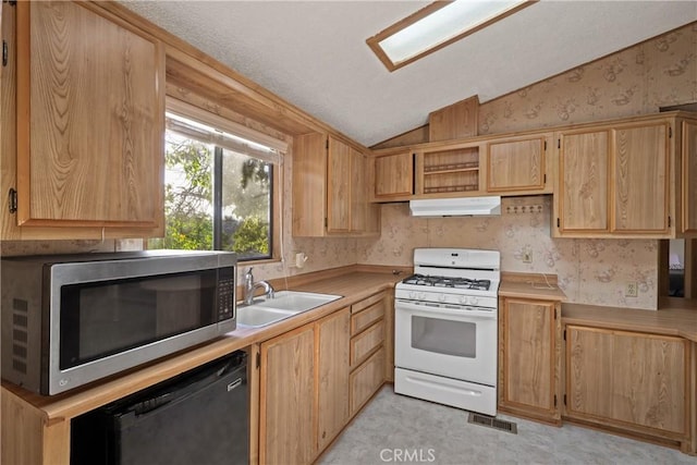 kitchen featuring lofted ceiling, sink, gas range gas stove, light brown cabinets, and dishwasher