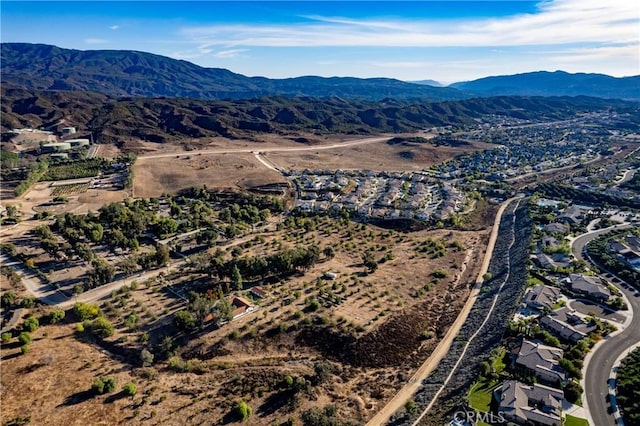 birds eye view of property featuring a mountain view