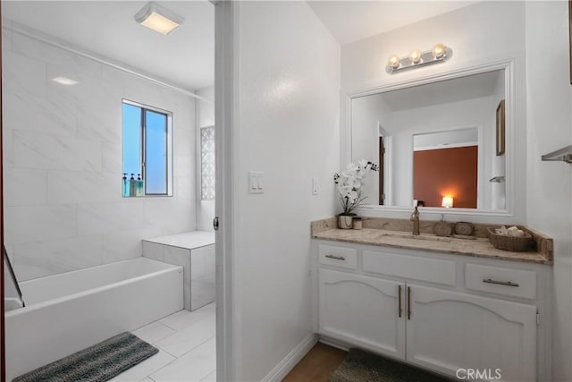 bathroom with vanity and tiled shower / bath